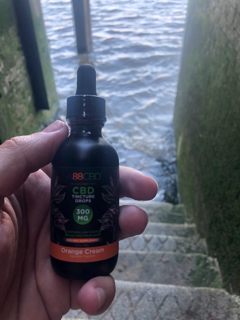 Orange Cream CBD Tincture on the steps leading down to River Thames