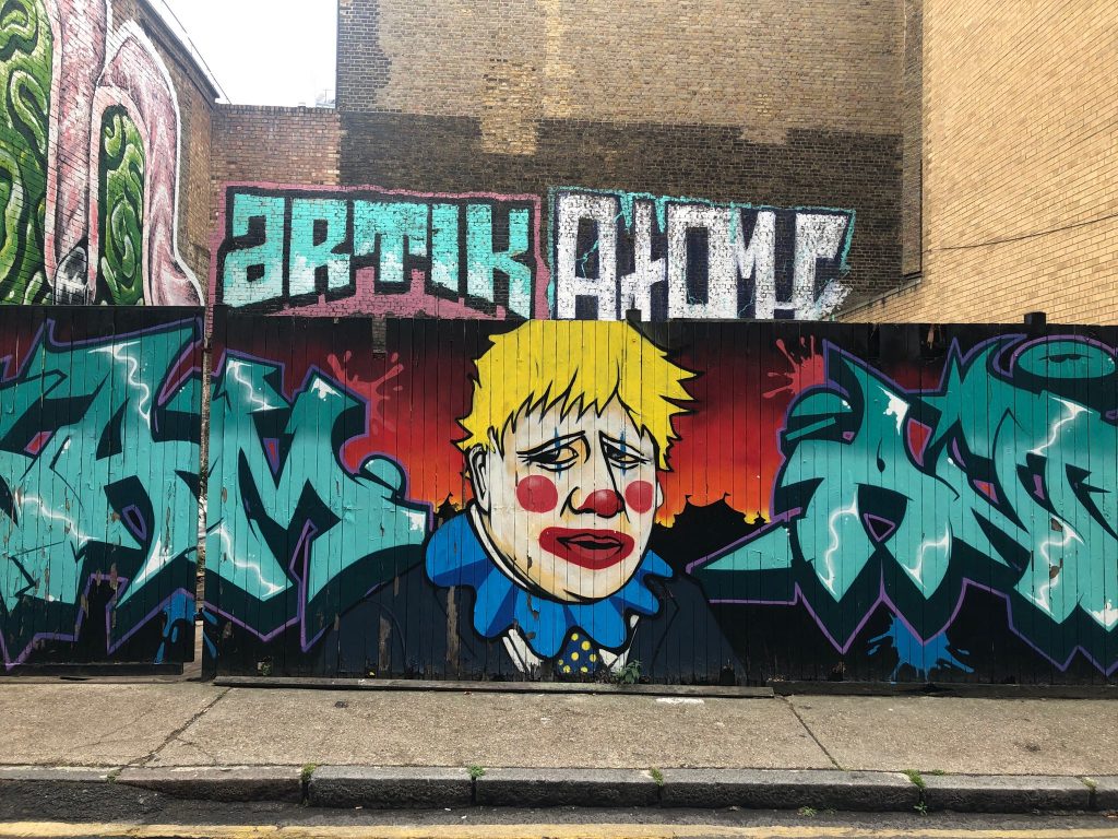 Brick Lane Graffiti Street Art - Boris Johnson UK Prime Minister Clown amid Covid 19 Pandemic NHS crisis